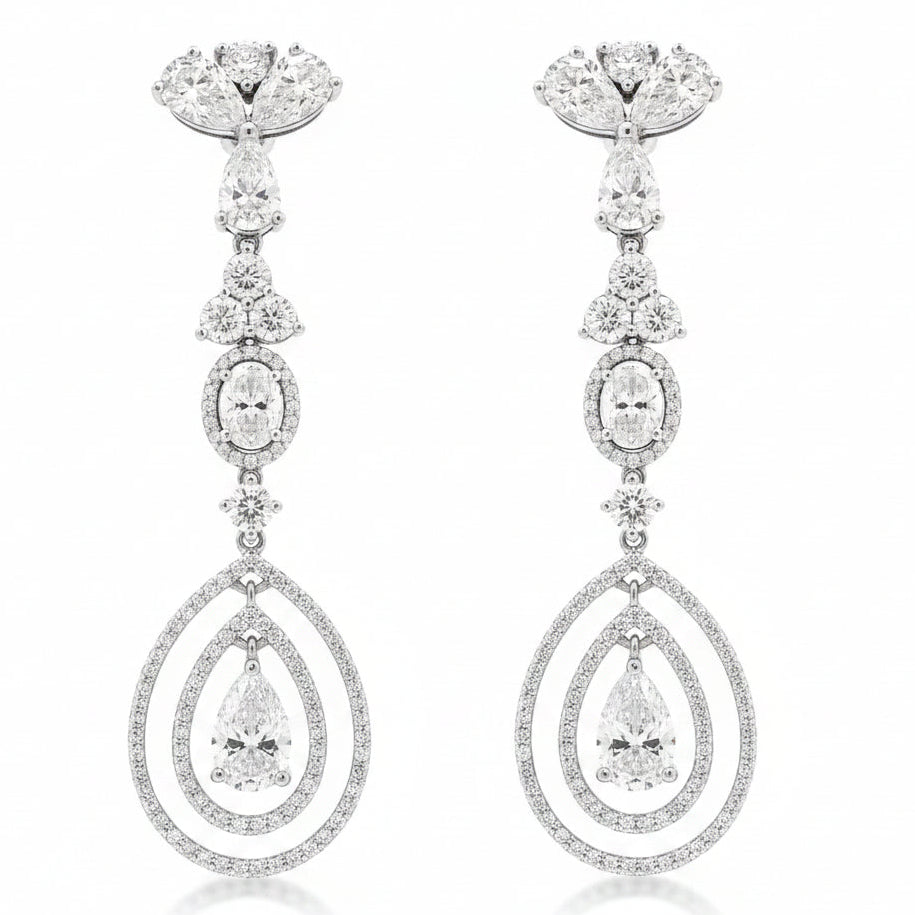 18k White Gold 12.68ctw Pear Oval and Round Brilliant Diamond Drop Earrings — worn on the finger