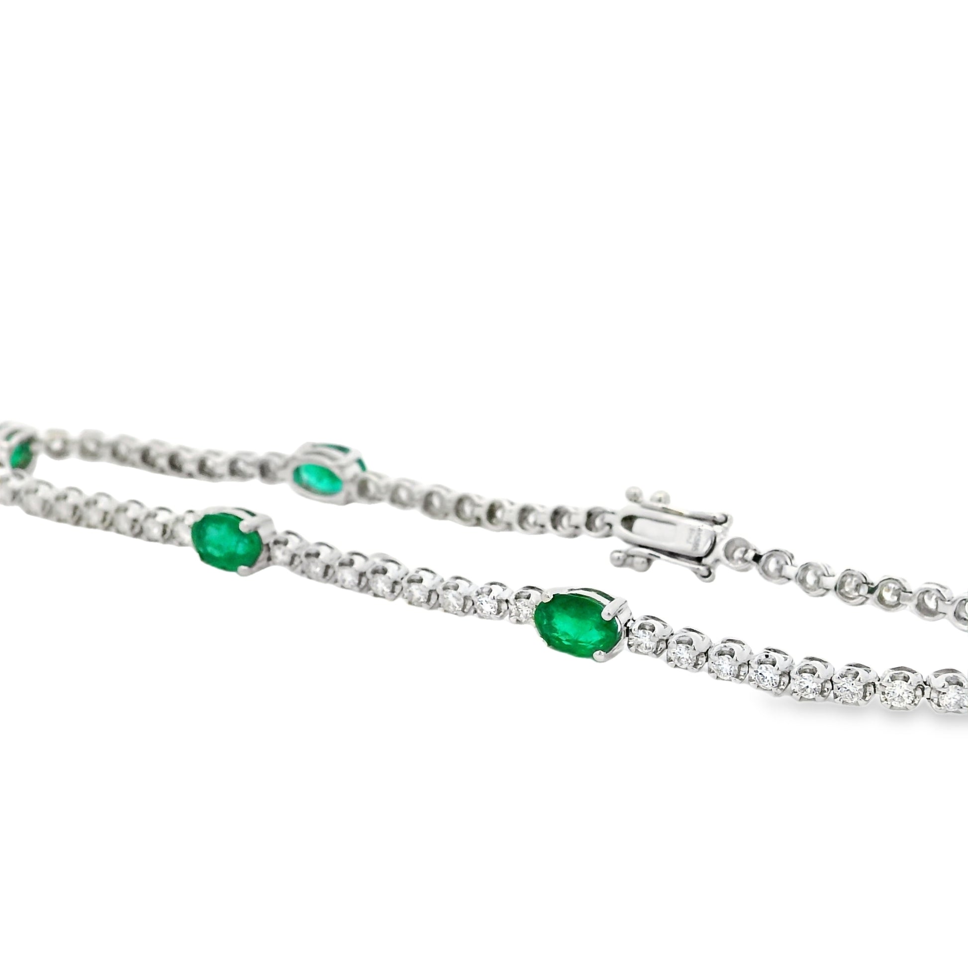14k White Gold 5.88ctw Oval Emerald and Round Brilliant Diamond Tennis Bracelet — worn on the wrist