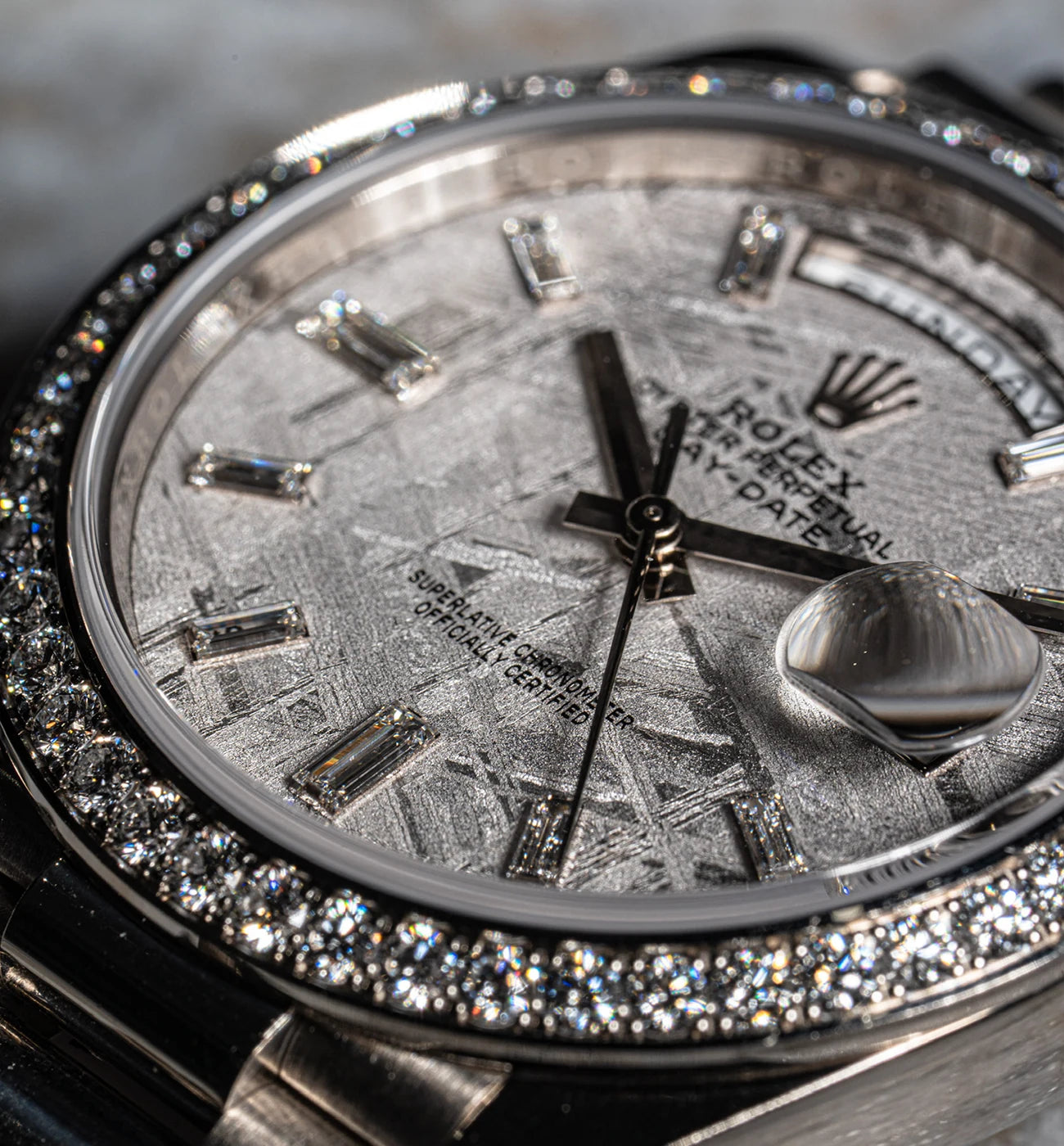 Close view of a Rolex dial with stone hour markers and a stone set bezel