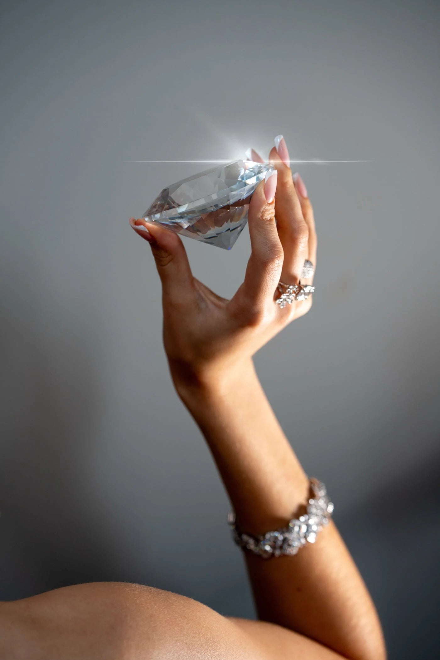 Bracelet and ring worn while holding a large faceted stone