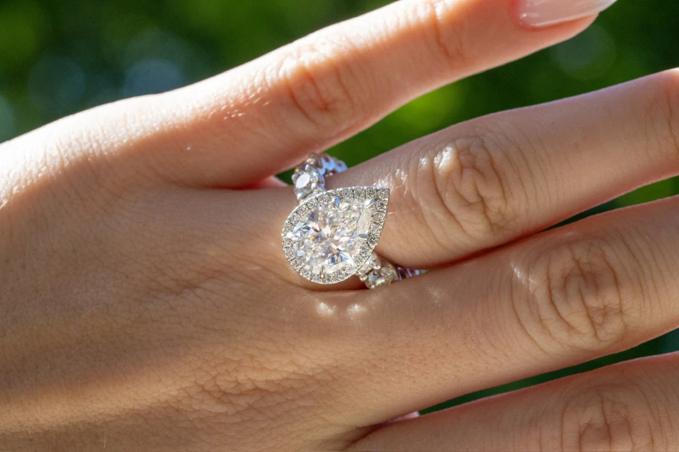 Pear shaped center stone ring worn on a hand