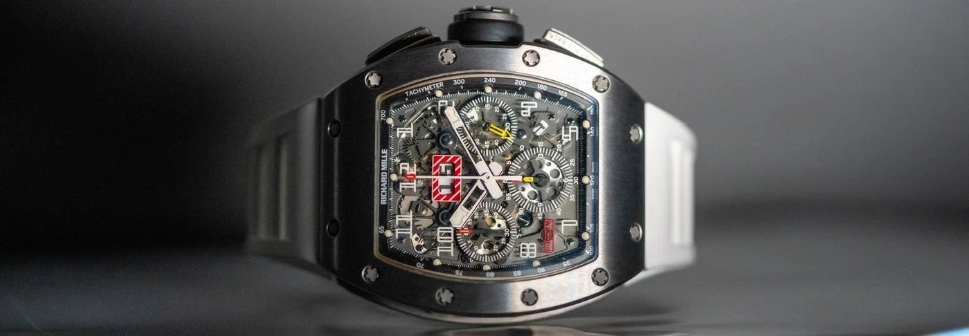 A close-up of a Richard Mille watch with a skeleton dial and black strap.