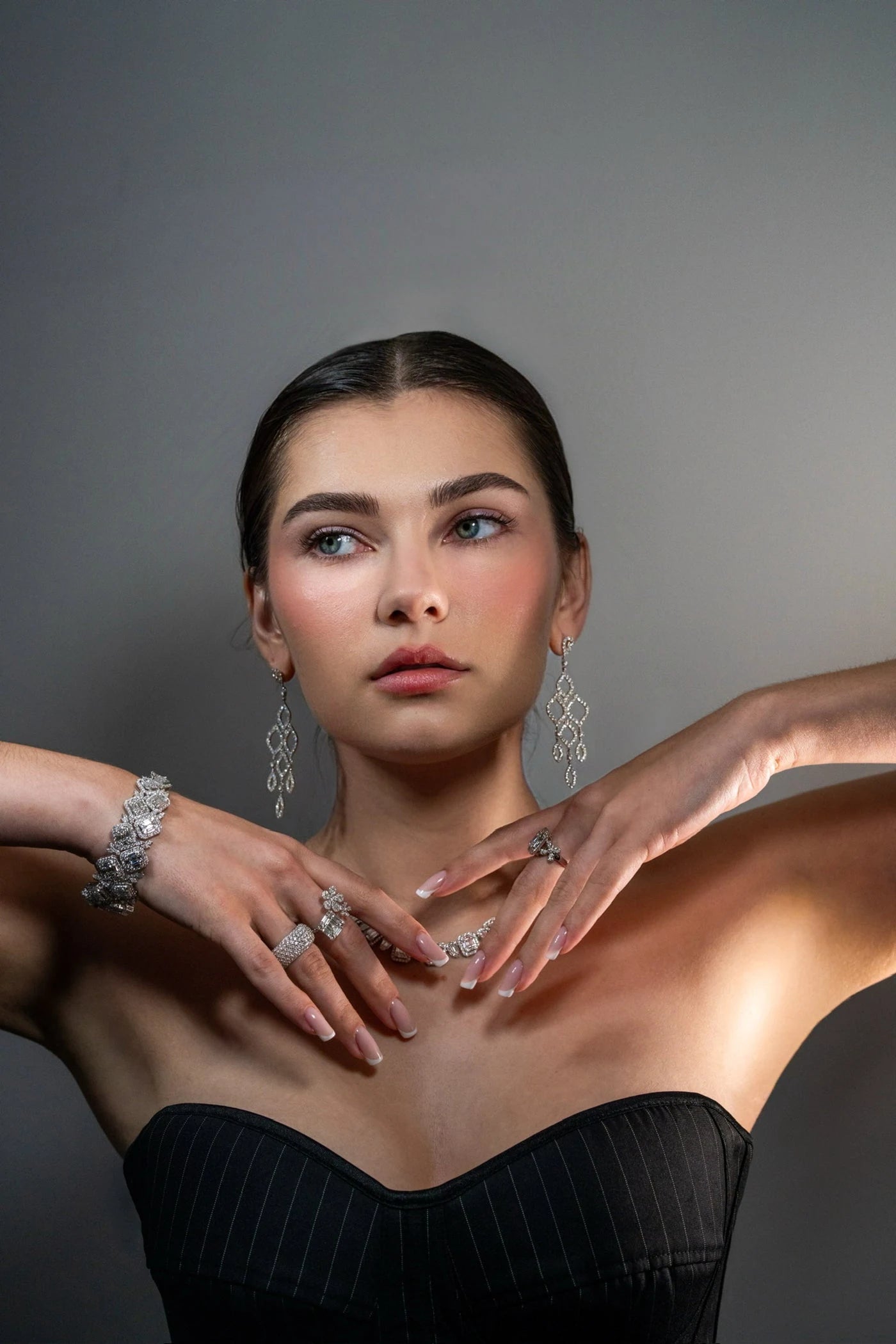Model wearing a necklace, bracelets and rings