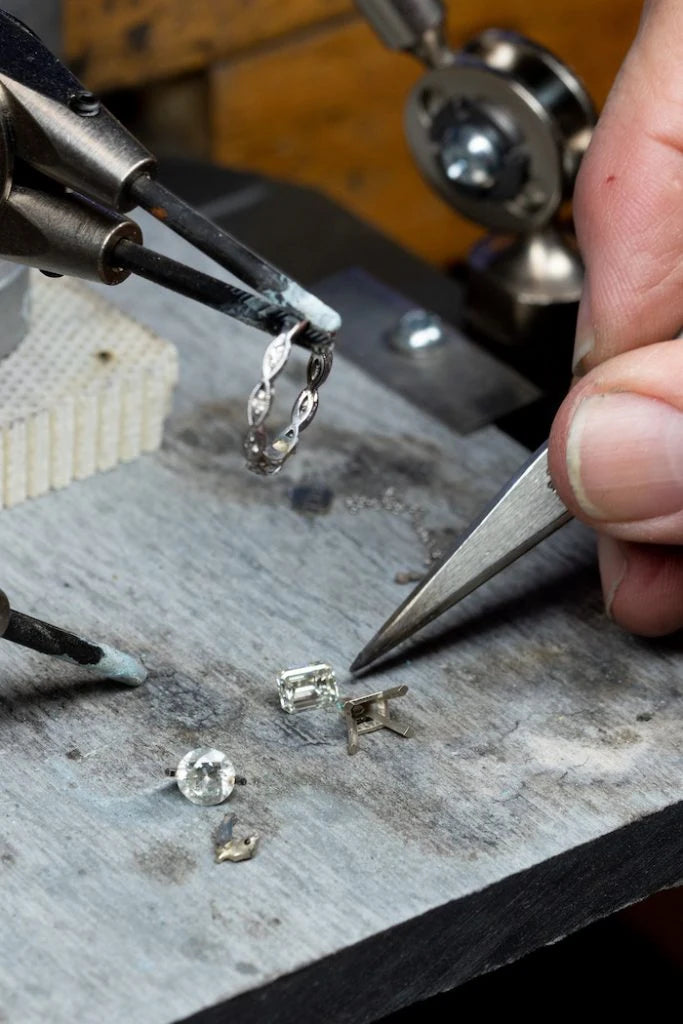 Jewelry tools and ring components on a workbench