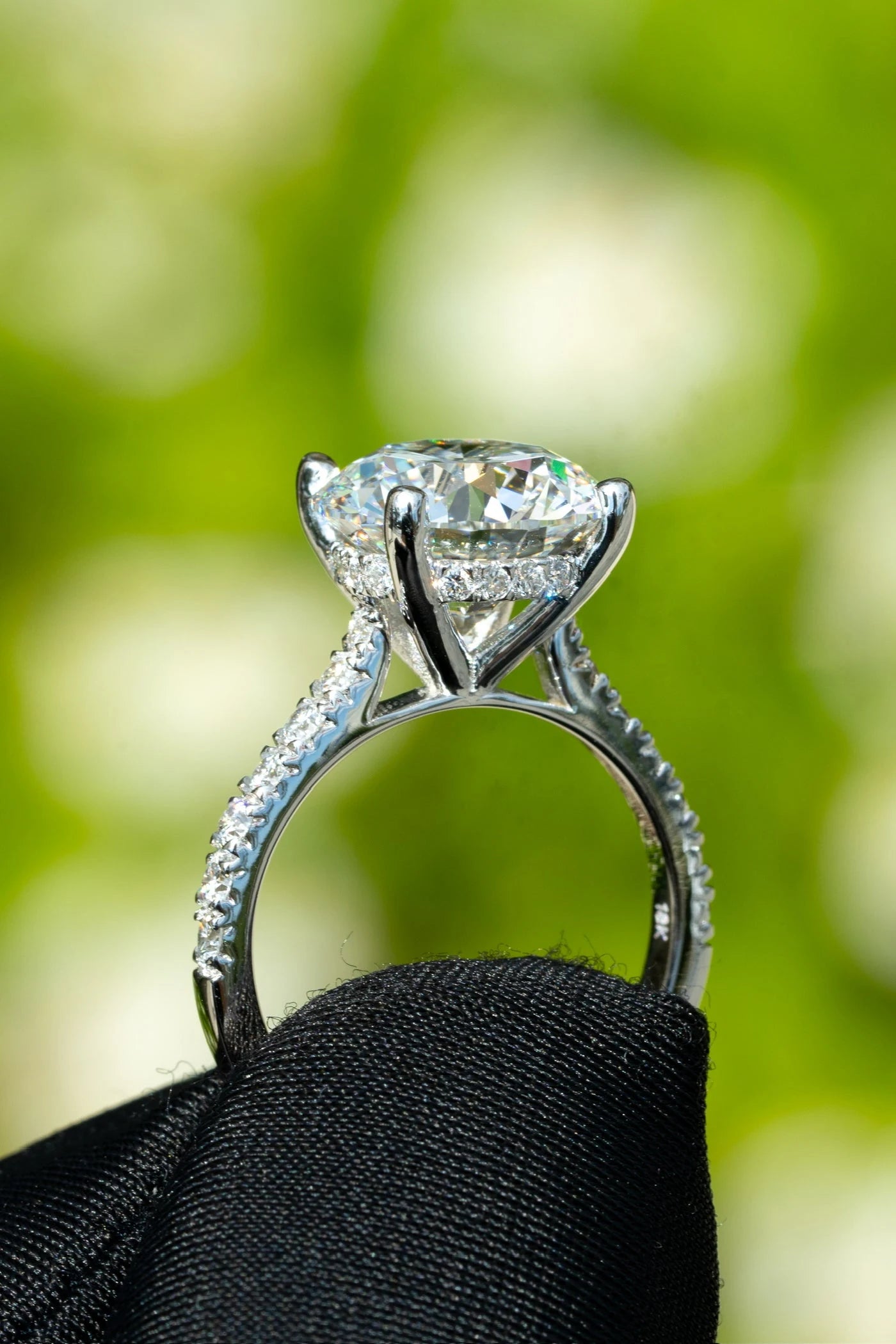 Side view of a ring with a raised center stone and stone set band