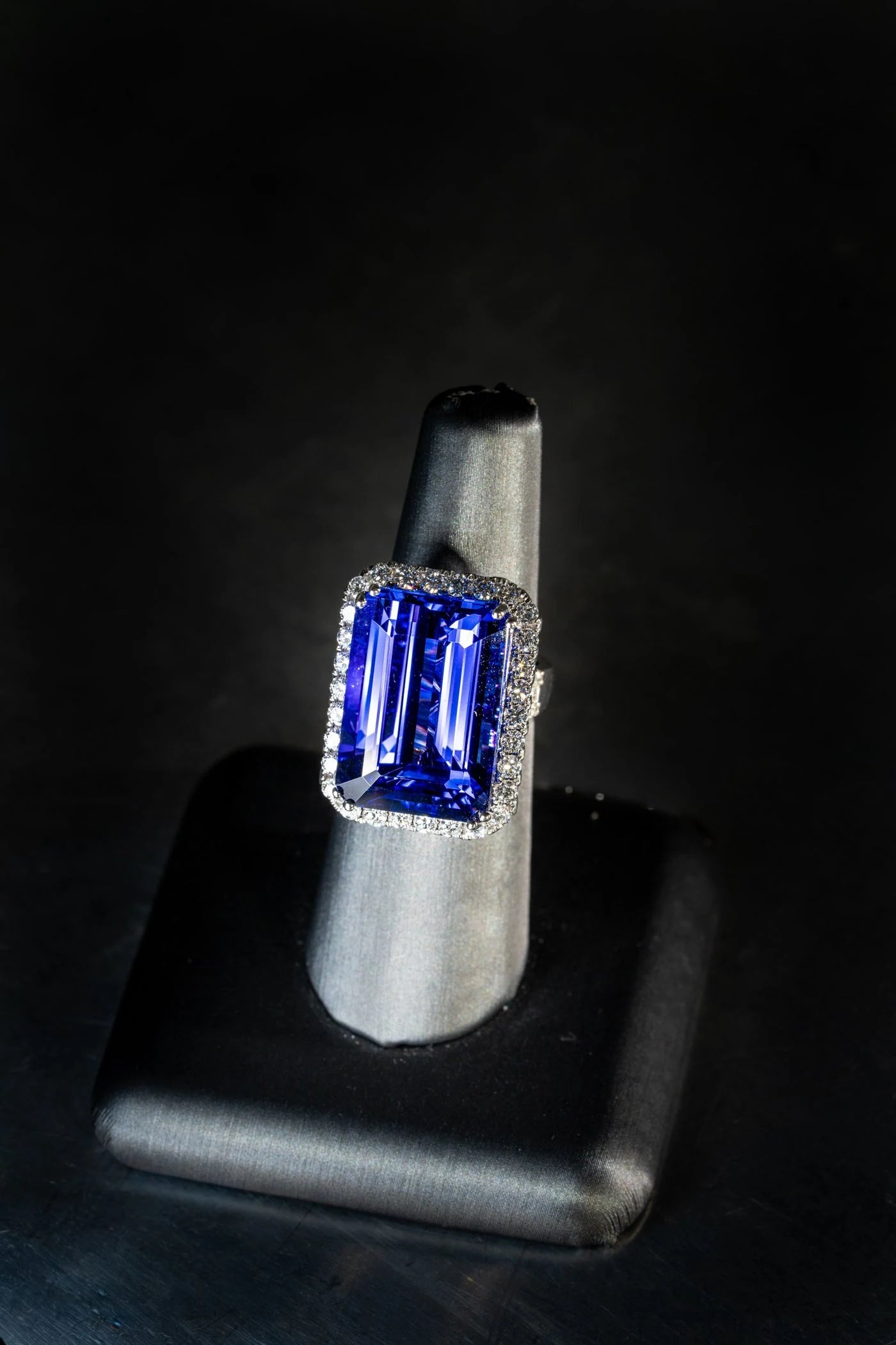 Violet-blue gemstone ring on a ring stand