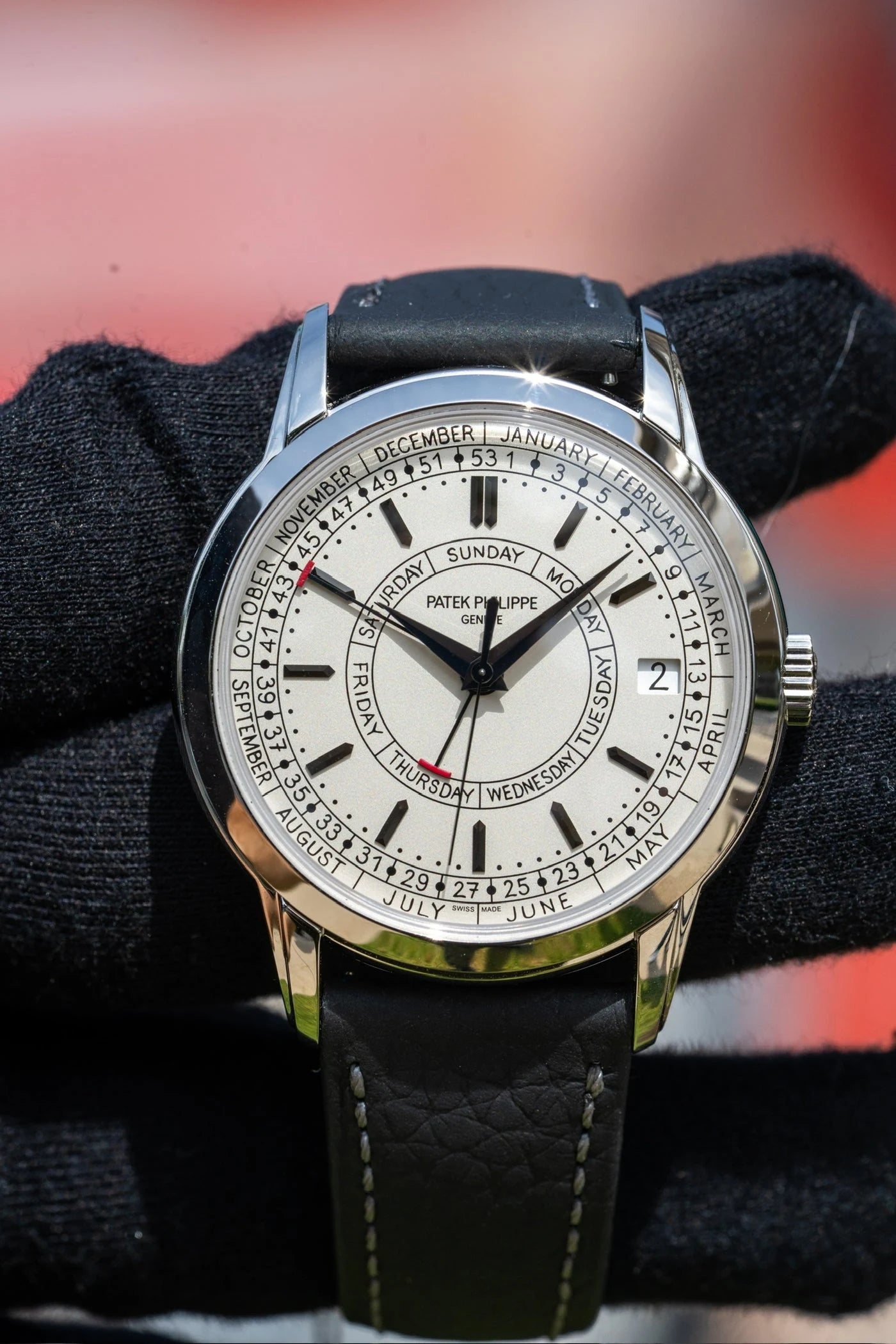 Patek Philippe calendar watch with a light dial and dark leather strap