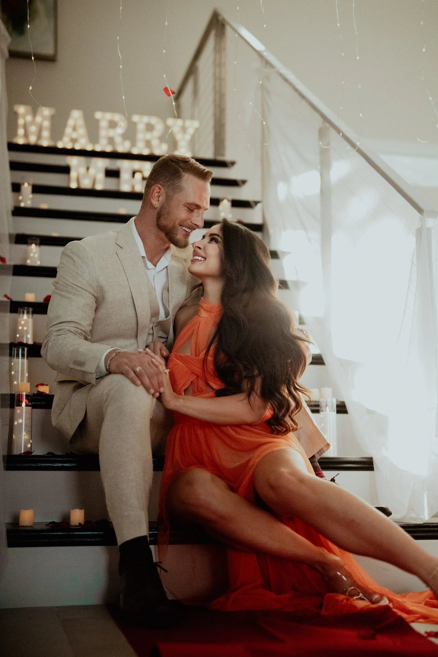 Couple seated together on a decorated staircase