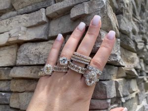 beautiful diamonds rings on finger in front of brick wall