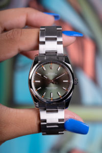 Rolex Oyster Perpetual watch with an olive green dial