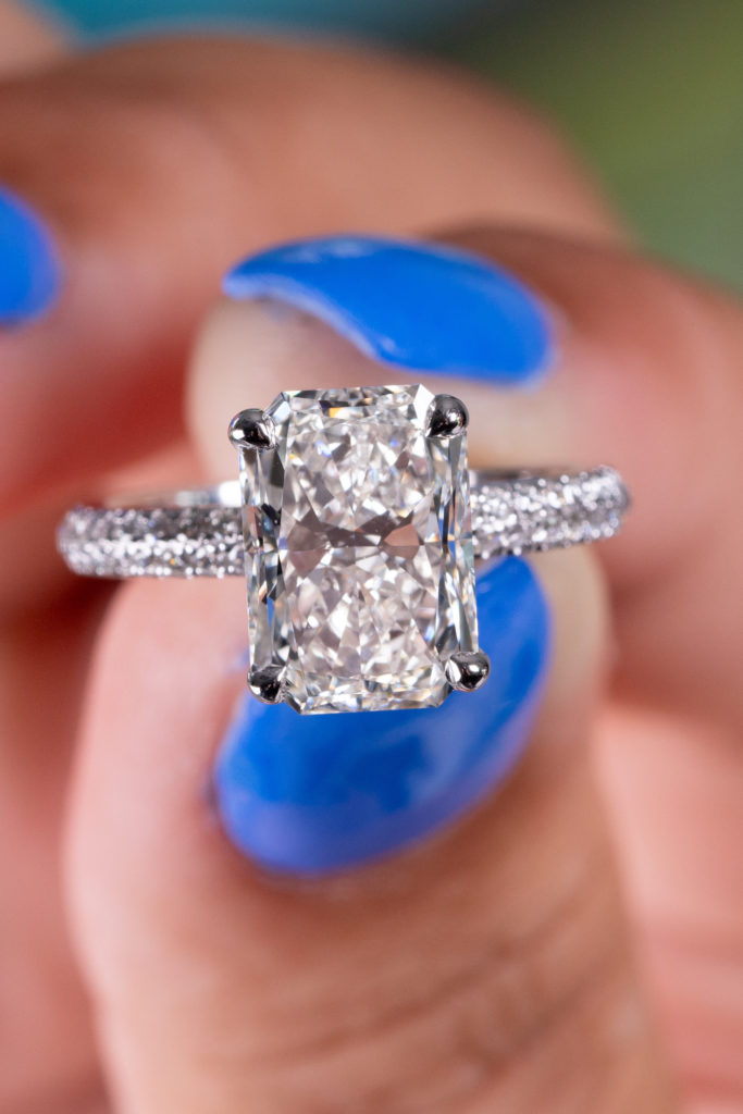 a white cushion cut diamond in an engagement ring