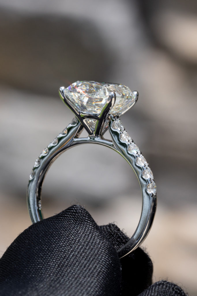 close up of an oval diamond in an engagement ring 