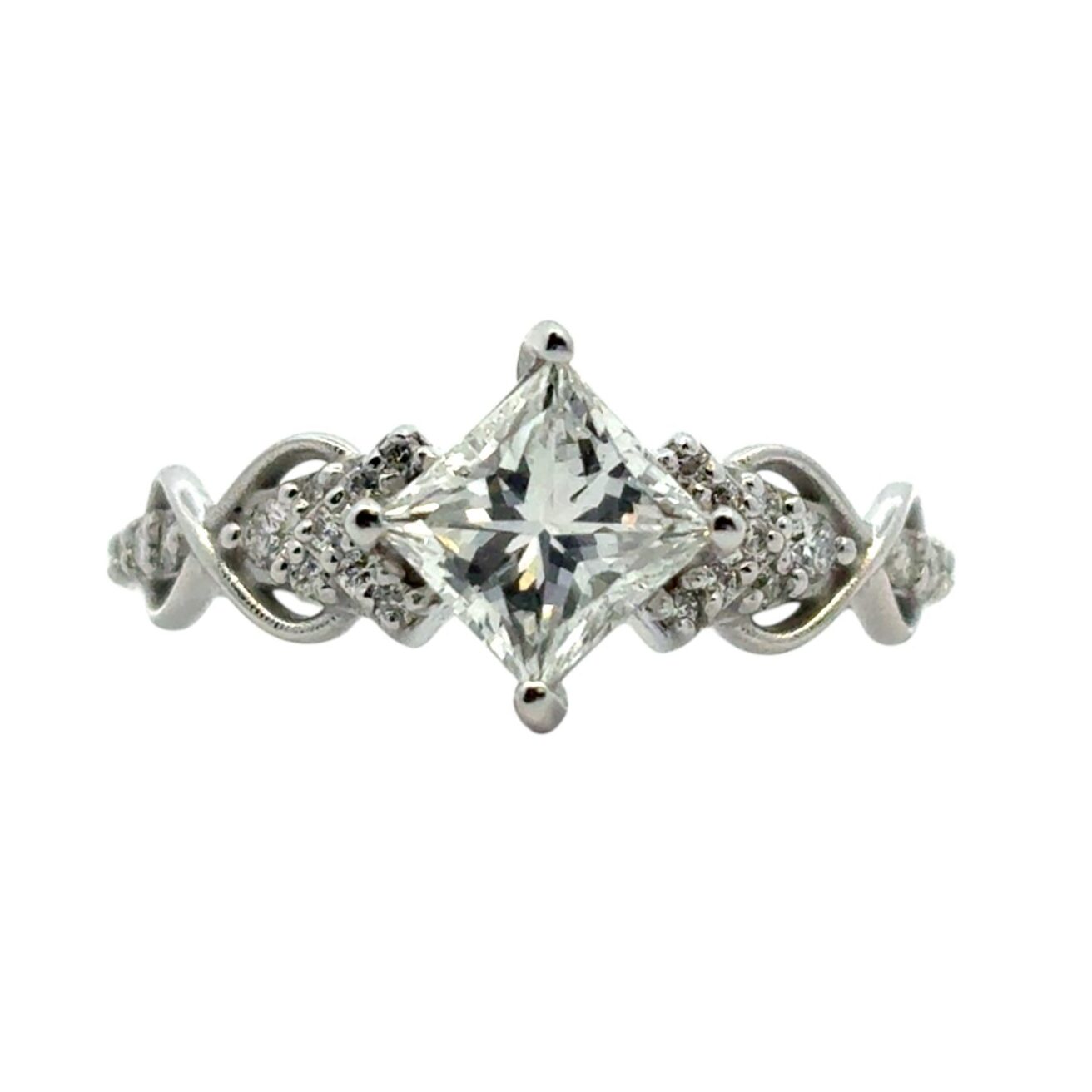 Princess cut diamond engagement ring with intricate band design, representing quality certified by a reliable diamond report.